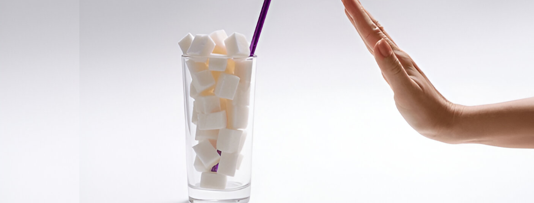 Woman’s hand stopping a full glass of sugar