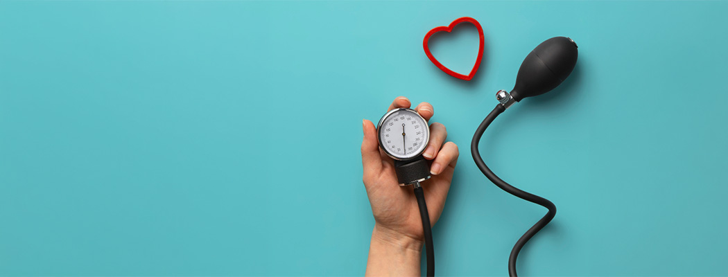 Hand holding a blood pressure gauge