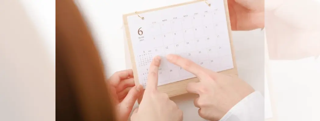 Couple planning pregnancy using calendar