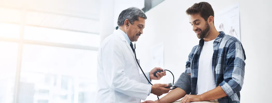 Doctor checking a patient’s blood pressure