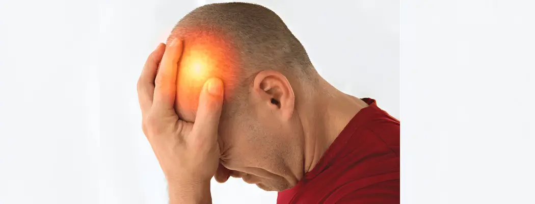 man holding head in pain, suffering from headache