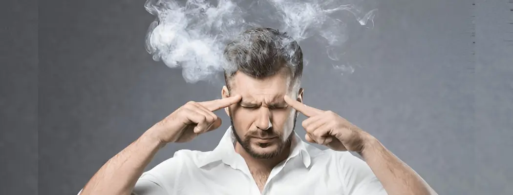 Person with smoke coming from head, showing stress or overload