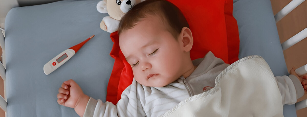 Sick baby boy sleeping in crib
