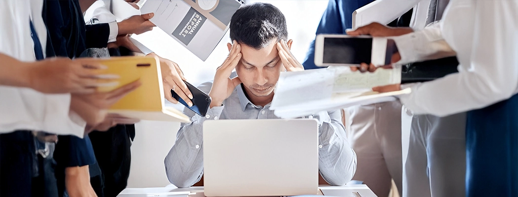 Businessman with hands on head due to stress headache