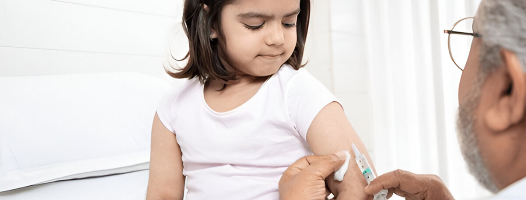 Pediatrician giving vaccine to child